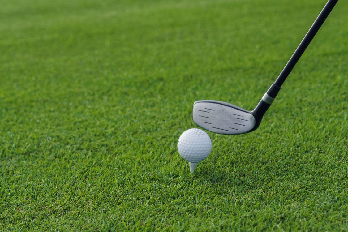 Golf club positioned beside a golf ball on the fairway, highlighting insured cash prize opportunities.