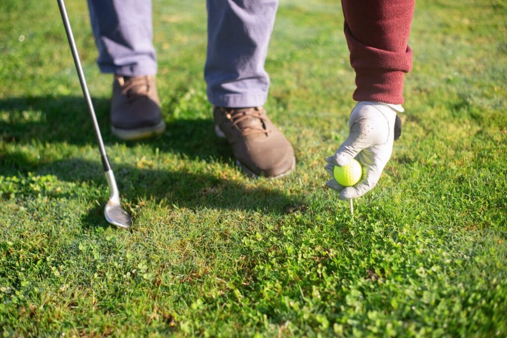 A person holding a golf ball