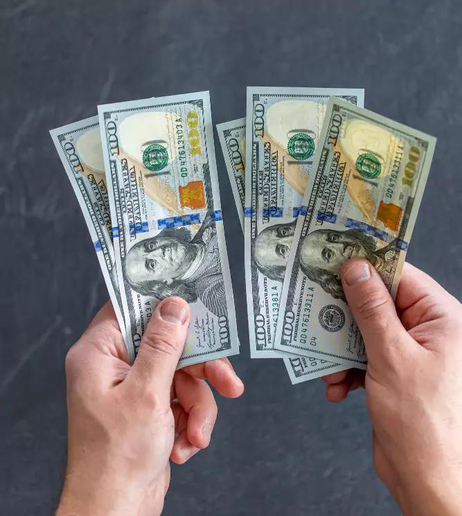 A person holding a cash prize