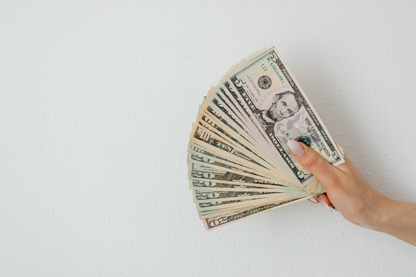 A person holding cash 