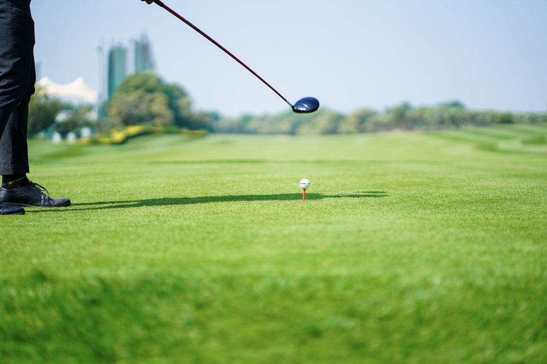 Anonymous golf player preparing to hit a ball