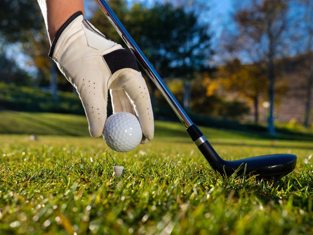 A person holding a golf ball