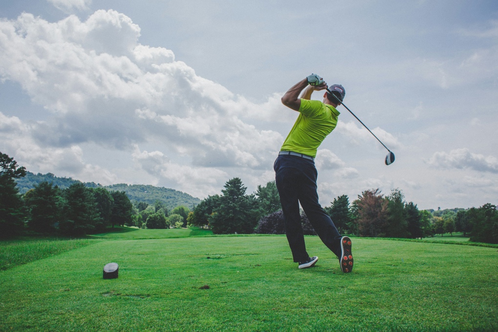Golfer taking tee shot