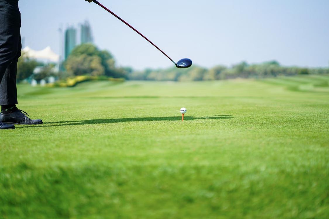 An image of a person preparing to hit a golf ball