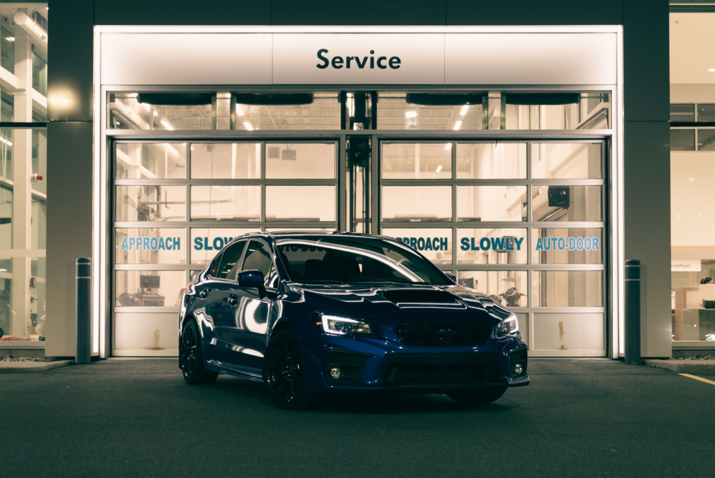 Blue car at night in a service center